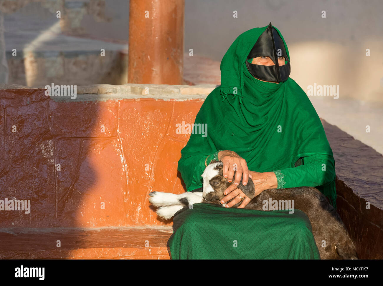 Nizwa, Oman, am 15. Dezember, 2016: Omani Frau mit einem Baby Ziege, die den Markt Stockfoto