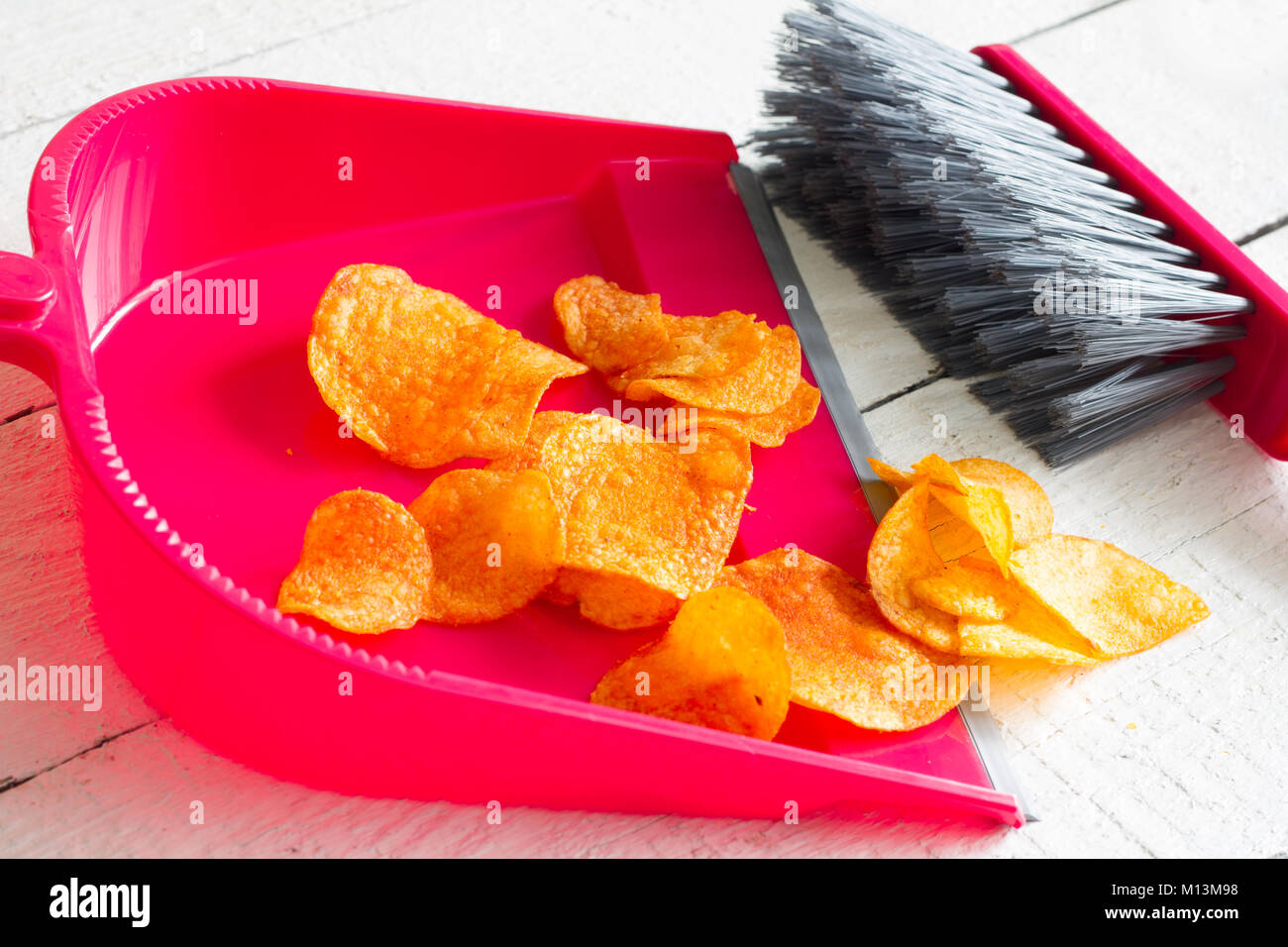 Fegen Junk Food mit Chips und Kehrblech Konzept der Gesundheit detox Diät Stockfoto