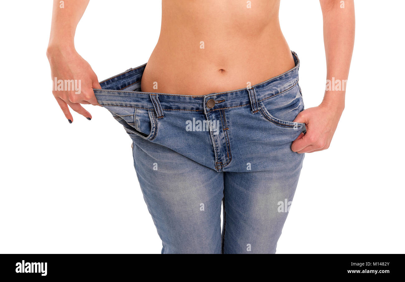 Frau zeigt, dass Sie Gewicht verloren hat. Big Jeans. Stockfoto