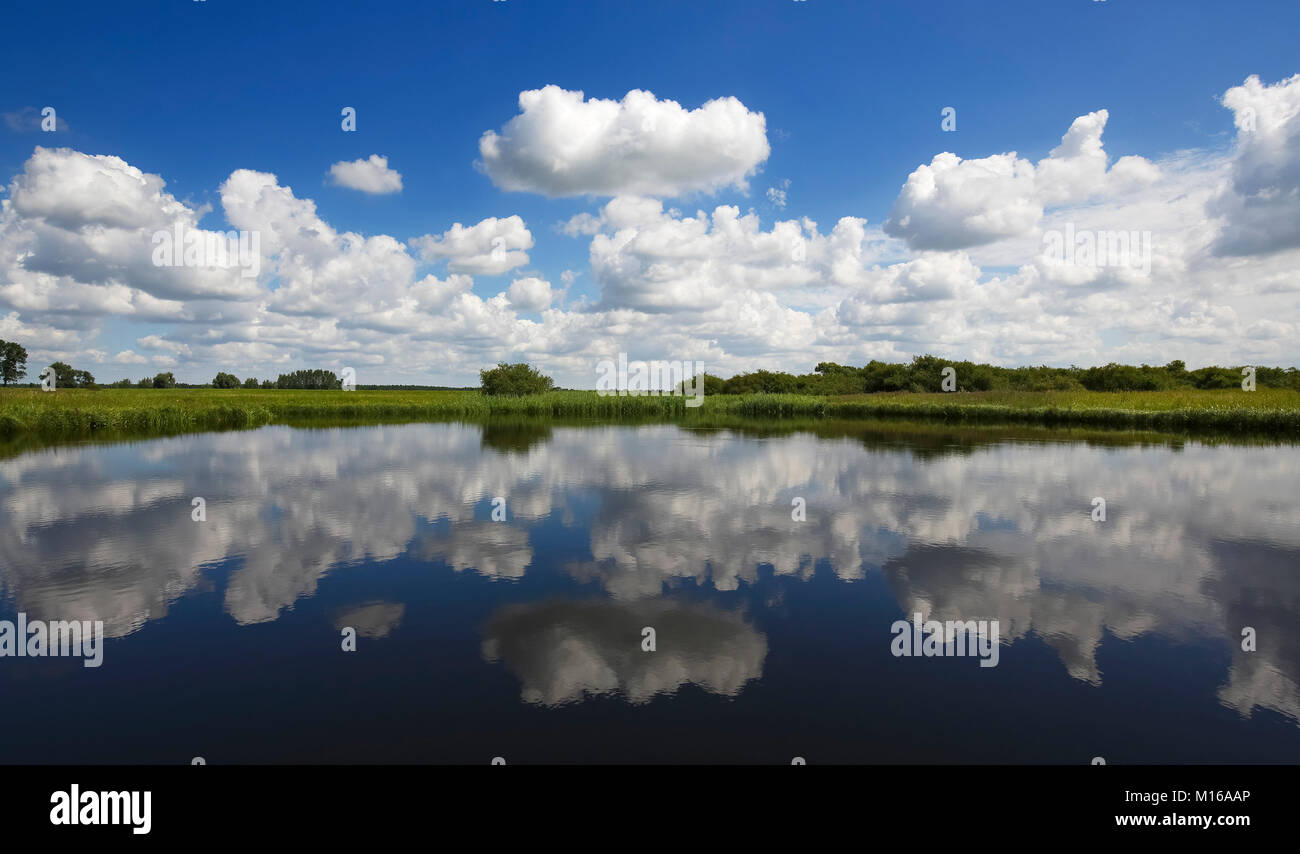 Fluss Sude mit bewölktem Himmel, der Reflexion, des UNESCO-Biosphärenreservat Flusslandschaft Elbe, Mecklenburg-Vorpommern, Deutschland Stockfoto