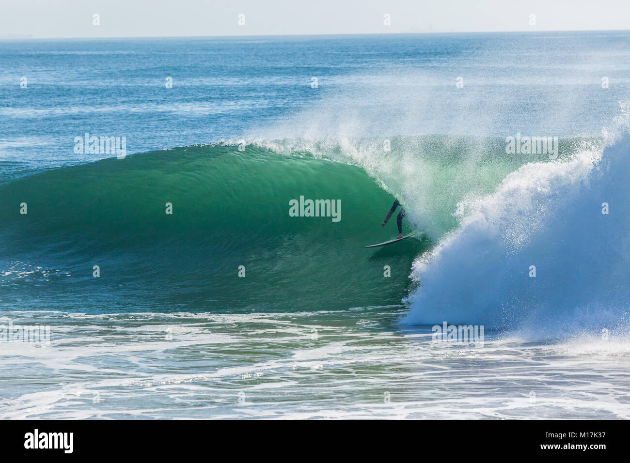 Surfer Surfen hohlen Ocean Wave für eine Fahrt mit der U-Bahn closeup Foto Aktion. Stockfoto