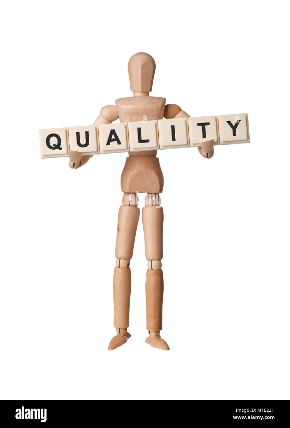 Holz- Figur mit dem Wort Qualität auf weißem Hintergrund Stockfoto
