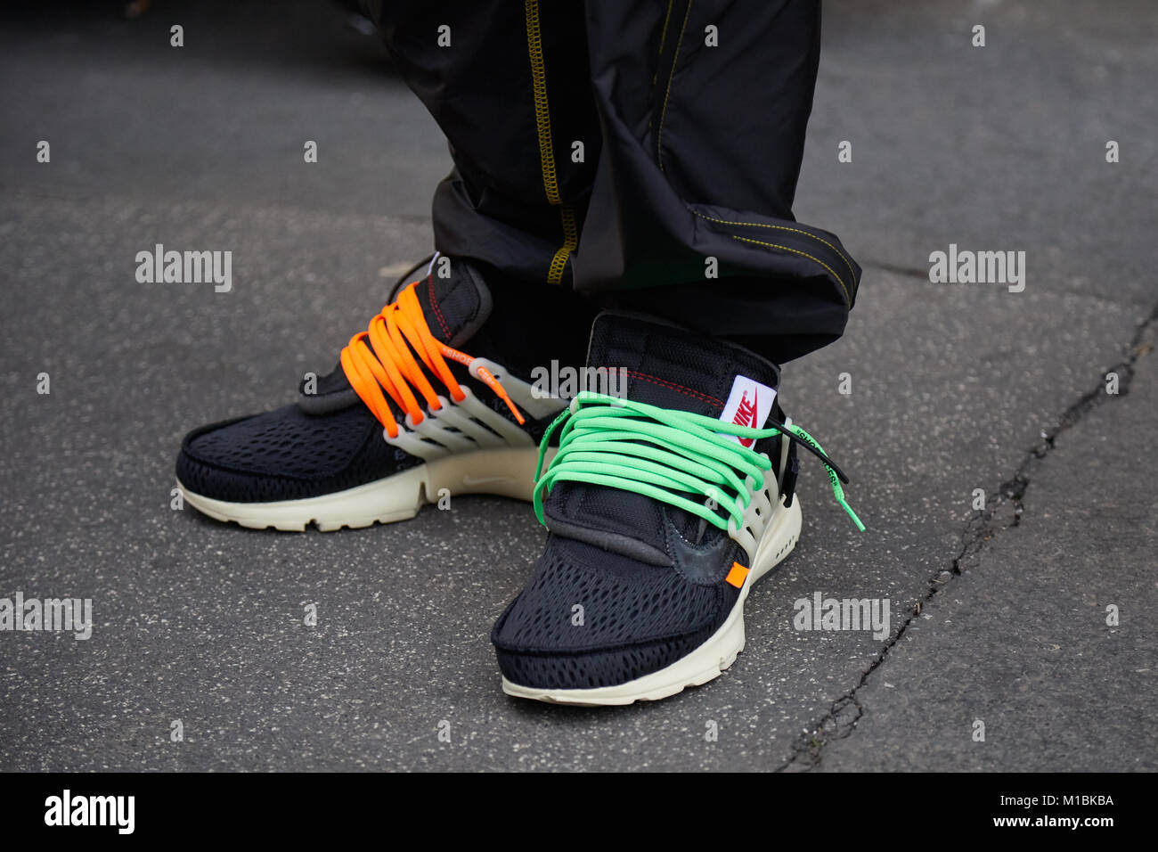 Mailand - Januar 15: Mann mit schwarzen Nike Schuhe mit orange und grün  Schnürsenkel vor fashion show darstellen, Mailand Fashion Week street style  April Stockfotografie - Alamy