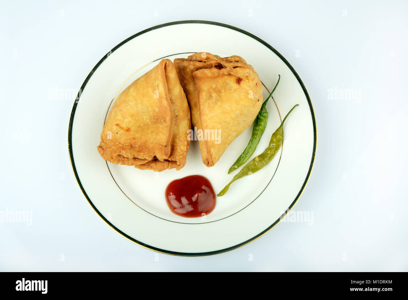 Indische veg. Samosa mit Tomatenketchup und gebratene grüne Kühl Stockfoto