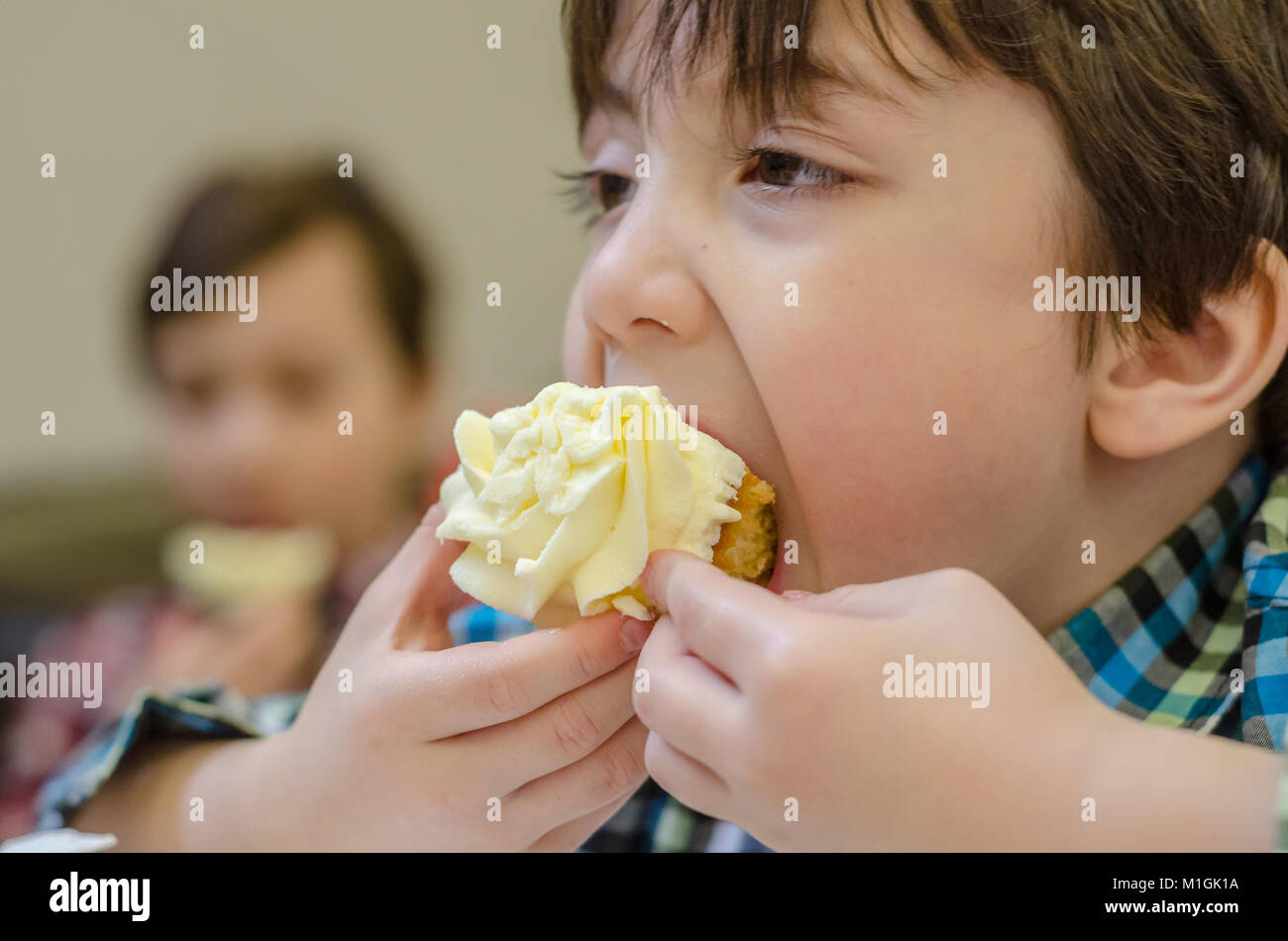 Eine Nahaufnahme eines Jungen essen eine Cupcake. Stockfoto