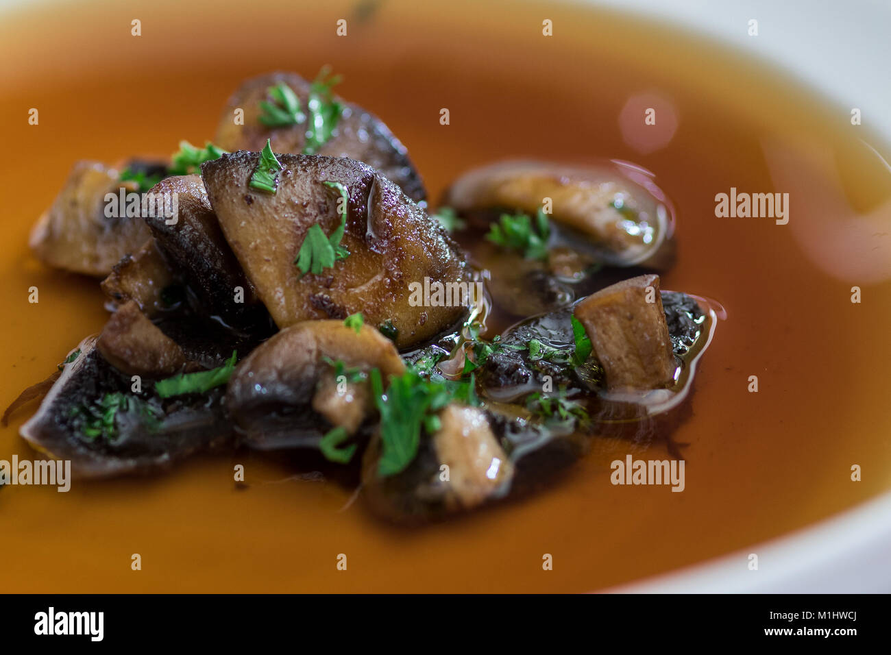 Gebratene Champignons in Beef Consomme Stockfoto