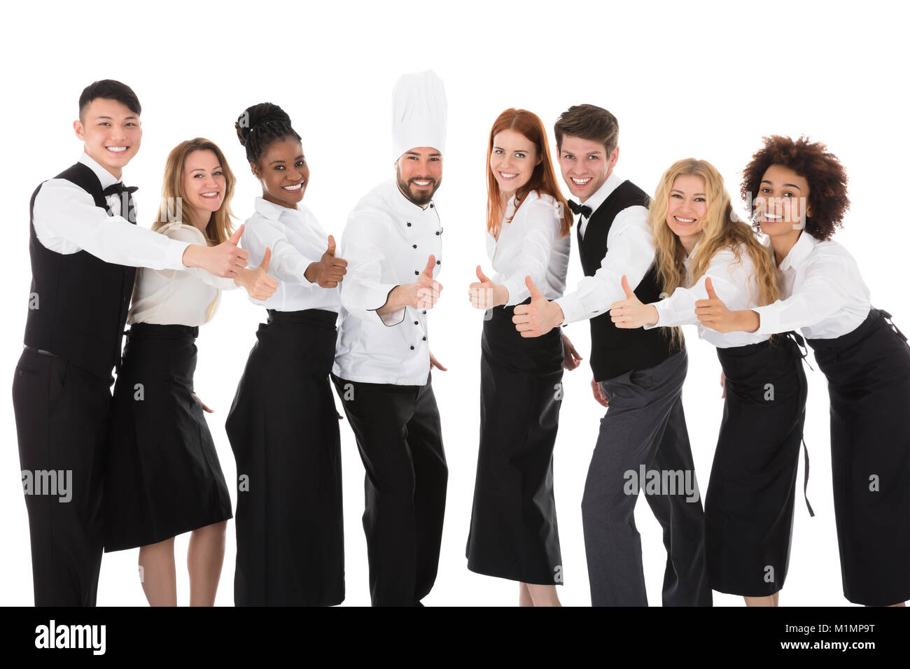 Lächelnde Personal im Restaurant Gestik Daumen hoch gegen den weißen Hintergrund Stockfoto