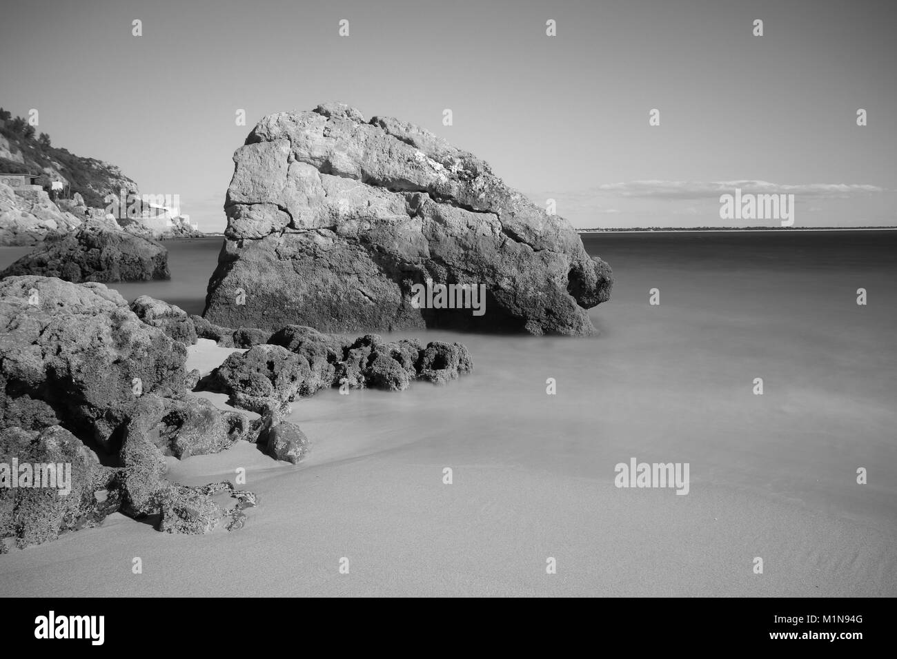 Strand mit türkisblauen Wasser Wasser mit Steinen. langen Belichtungszeit. Portugal Stockfoto