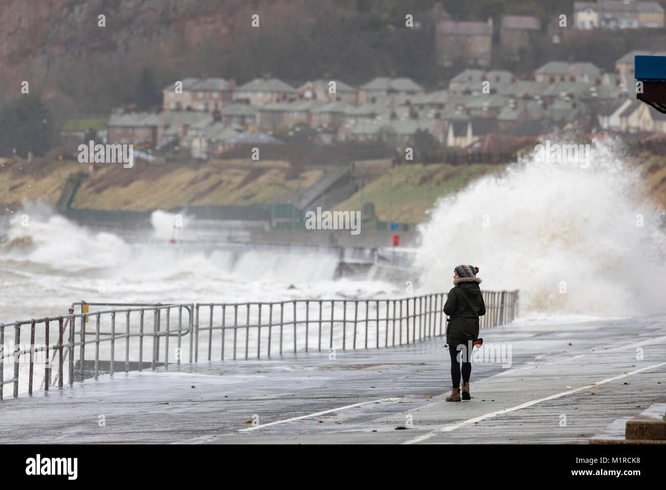 Colwyn Bay, Conwy County, Wales, Großbritannien, 1. Februar 2018, UK Wetter: Kalt mit Flut und windigem Wetter haben ideale Bedingungen für natürliche Ressourcen Wales Hochwasserwarnungen für die North Wales Küste einschließlich Colwyn Bay. Eine Person zu Fuß entlang der Promenade in Colwyn Bay als riesige Wellen Teig der Küstenort mit Hochwasserwarnungen, Conwy County, Wales © DGDImages/Alamy leben Nachrichten Stockfoto