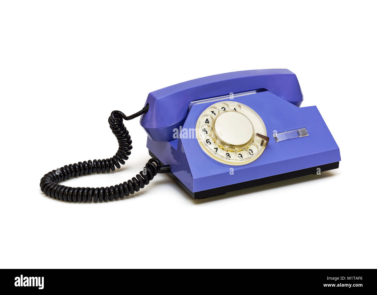 Auf einem weißen Hintergrund ist ein retro Telefon mit einem runden Dialer Stockfoto