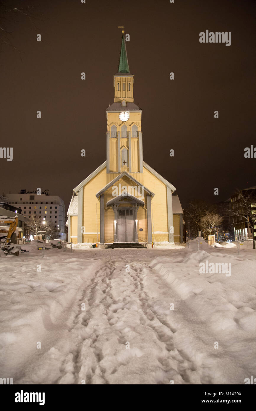 Tromsø Kathedrale (Tromsø Domkirke), mit Schnee und Abdrücke in den Vordergrund, sitzt vor einem dunklen Himmel während der Polarnacht in Tromsø, Norwegen. Stockfoto