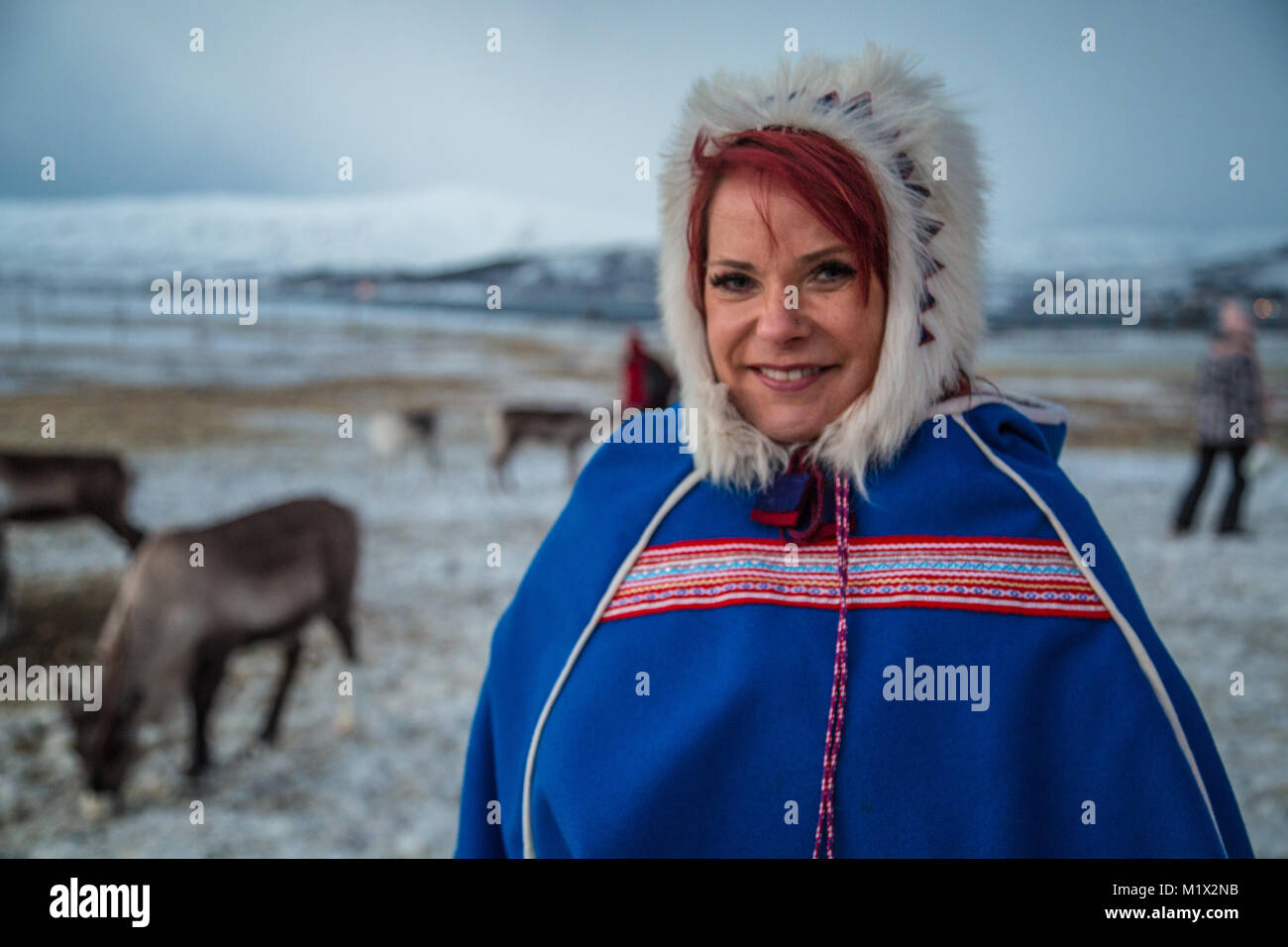 Das Porträt einer rothaarige Frau in traditionellen Sami Sami Kleid auf einer Rentierfarm außerhalb von Tromsø, Norwegen, im polaren Winter. Stockfoto