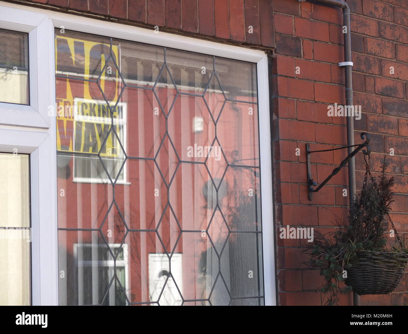 'No Fracking Weg!': eine anti-fracking Plakat in einem Fenster eines Hauses auf einer Straße mit Reihenhäusern in Clowne, North East Derbyshire. INEOS Plan im Bereich zu bohren Stockfoto