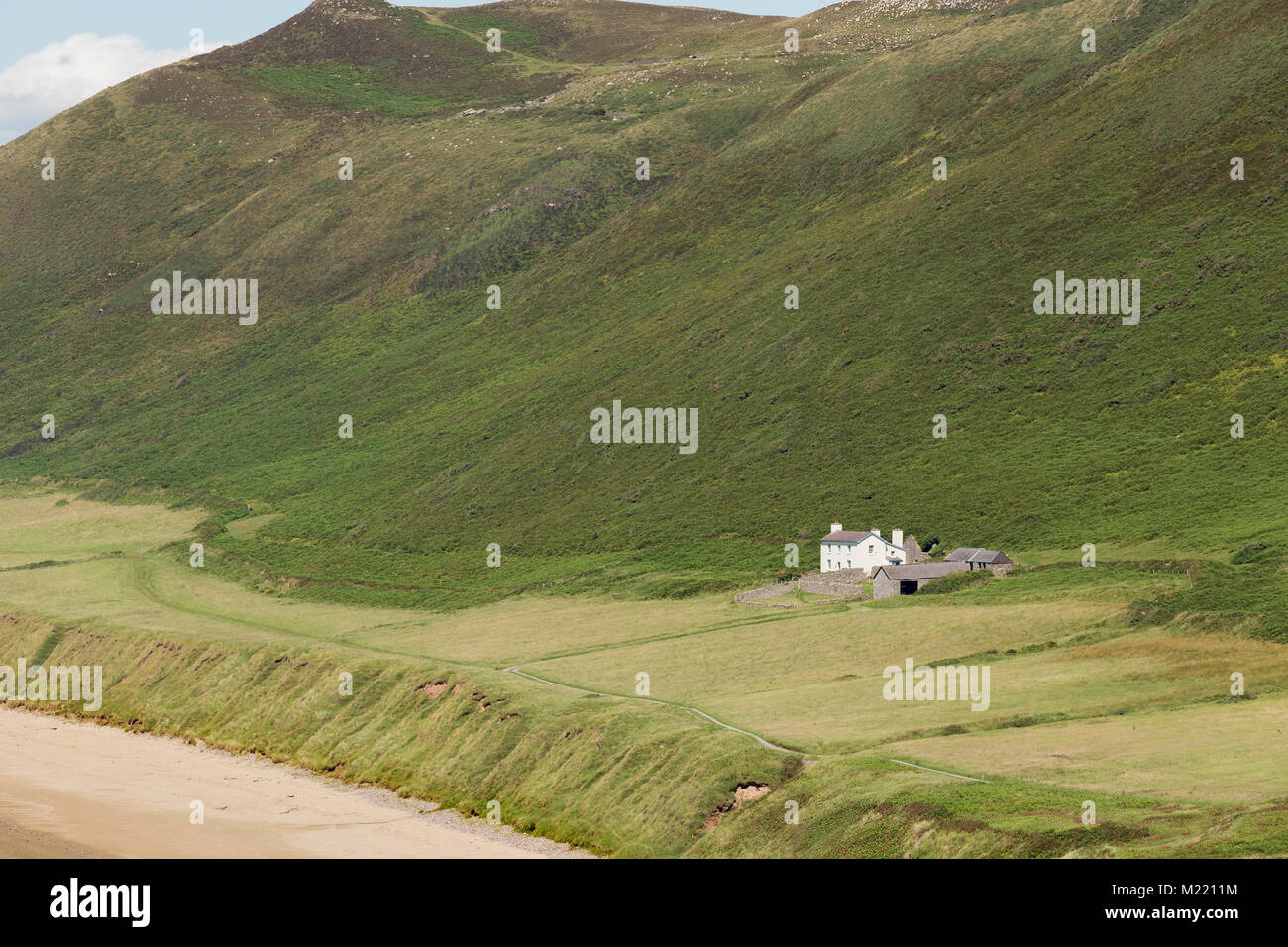 Ein Bild von einem Beachside cottage in Einsamkeit Schuß an Rhossili Bay, South Wales, Großbritannien Stockfoto