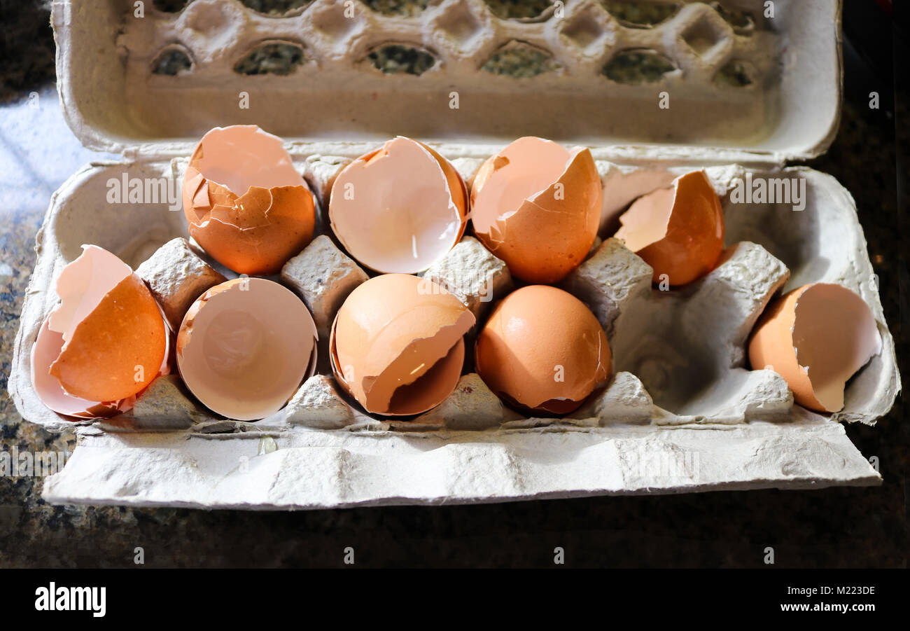 Gebrochene Eierschalen aus Eiern, die für das Kochen in Papiermache ei Karton auf Marmor Arbeitsplatte verwendet Stockfoto