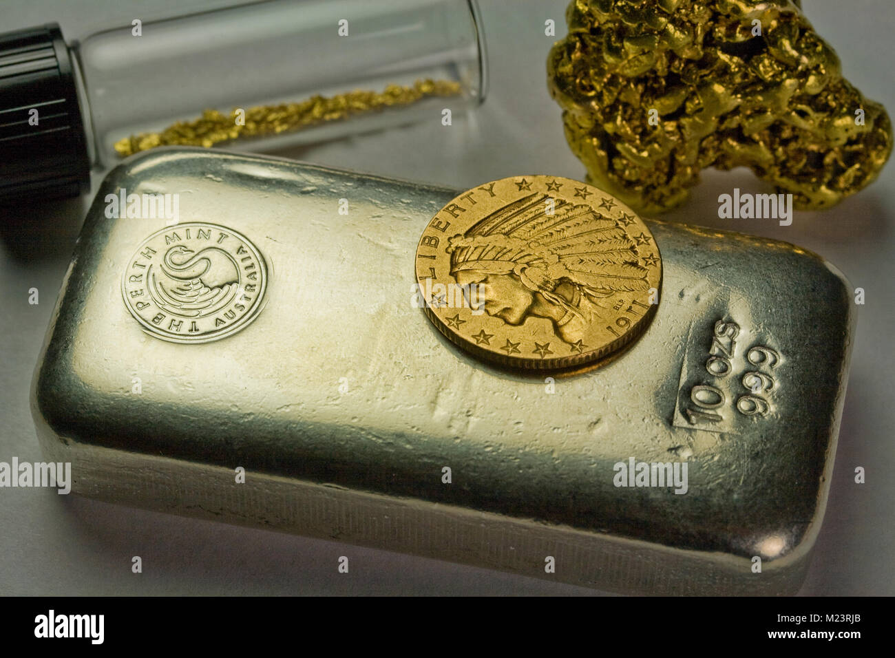 10 Unze Silber Bar, 1911 Gold $ 5 indische Münze und Rohstoffe Gold Nuggets Stockfoto