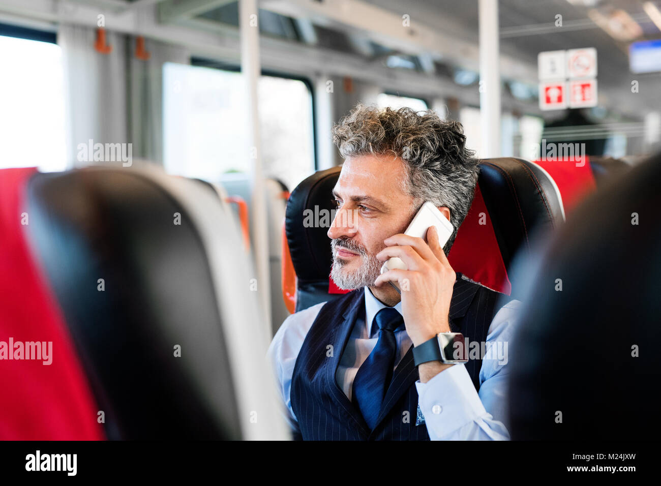 Reifen Geschäftsmann mit Smartphone, der mit dem Zug reist. Stockfoto