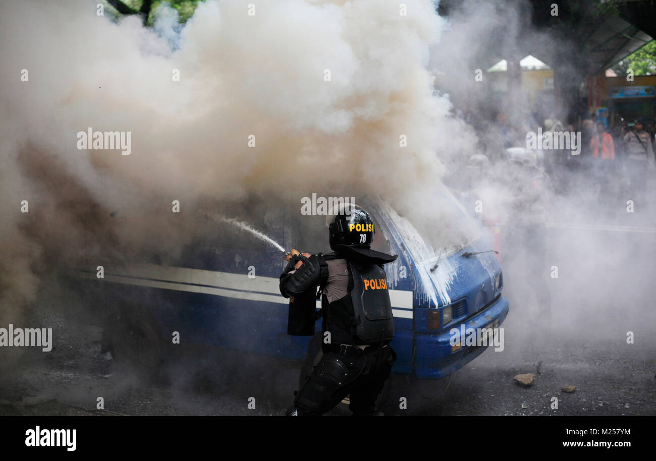 Bogor, Indonesien. 3. Februar, 2018, indonesische Polizei gelöscht ein Feuer in einem Auto, das in Brand während einer Demonstration der Simulation Sicherheit der Kommunalwahlen festgelegt wurde Stockfoto