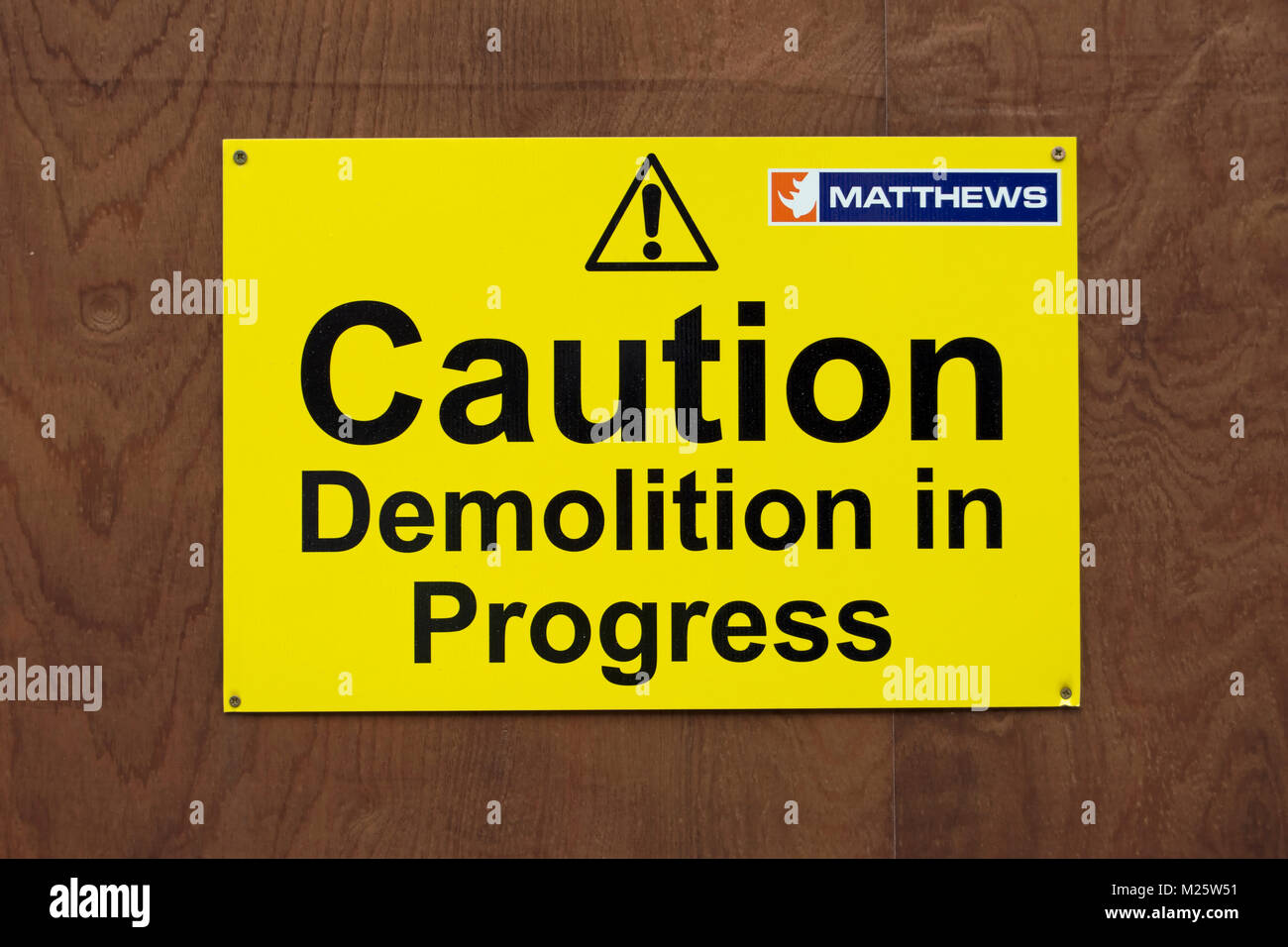 Vorsicht Abriss im Gange Warnschild, mit Ausrufezeichen und Logo der Demolition Company matthews Stockfoto