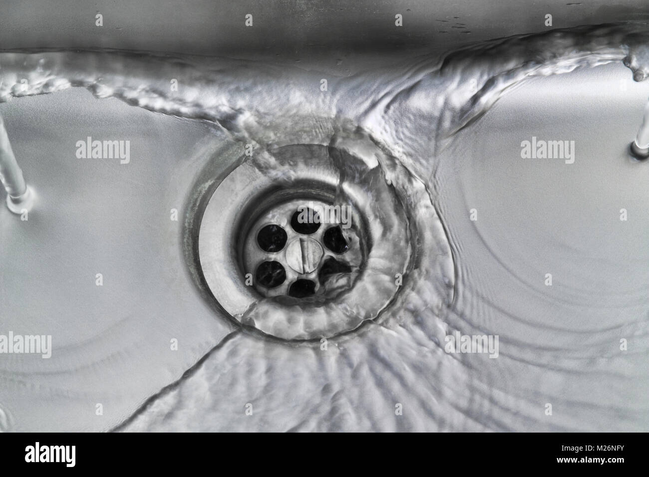 Fließendes Wasser ablassen aus Edelstahl von Hand waschen, Waschbecken in einer britischen Biowissenschaften Labor Stockfoto