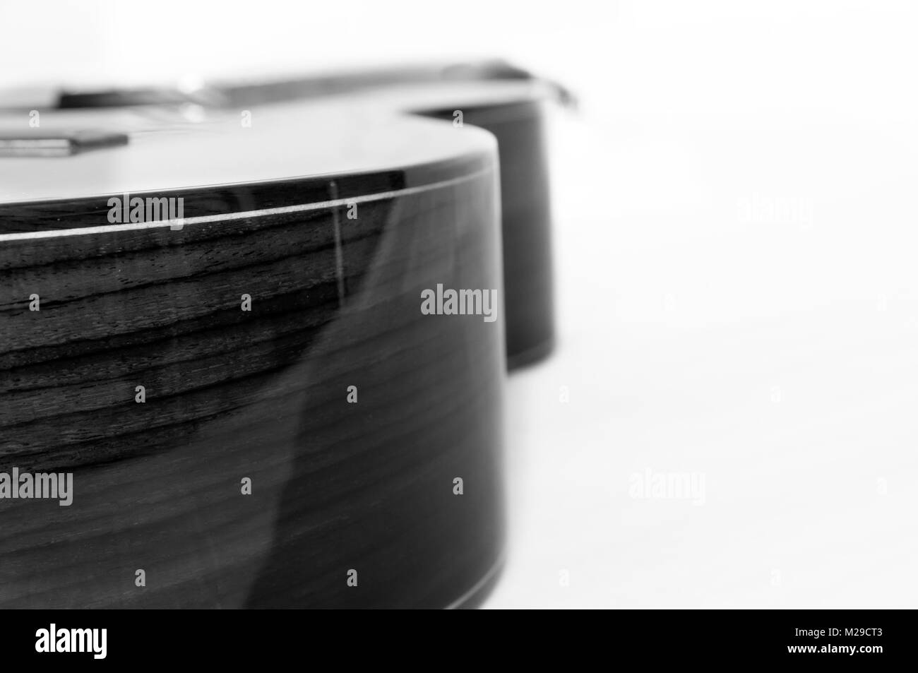 Schwarz-weiß Foto von einer klassischen Gitarre mit einem weißen Hintergrund. Stockfoto