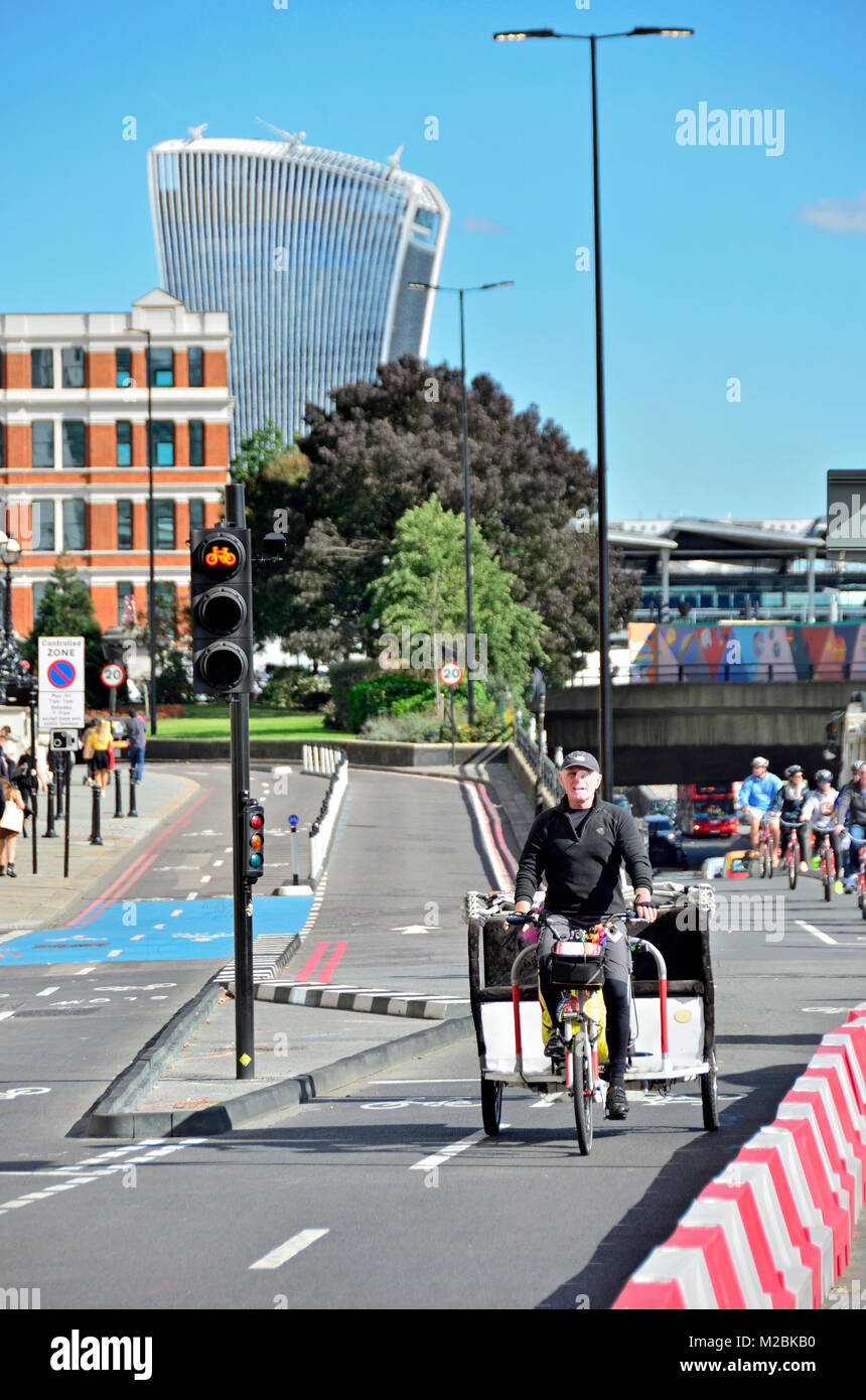 London, England, UK. Fahrrad Rikscha Fahrer in einem Radweg auf der Victoria Embankment in der Nähe von blackfriars und schaut in den Walkie Talkie Gebäude Stockfoto