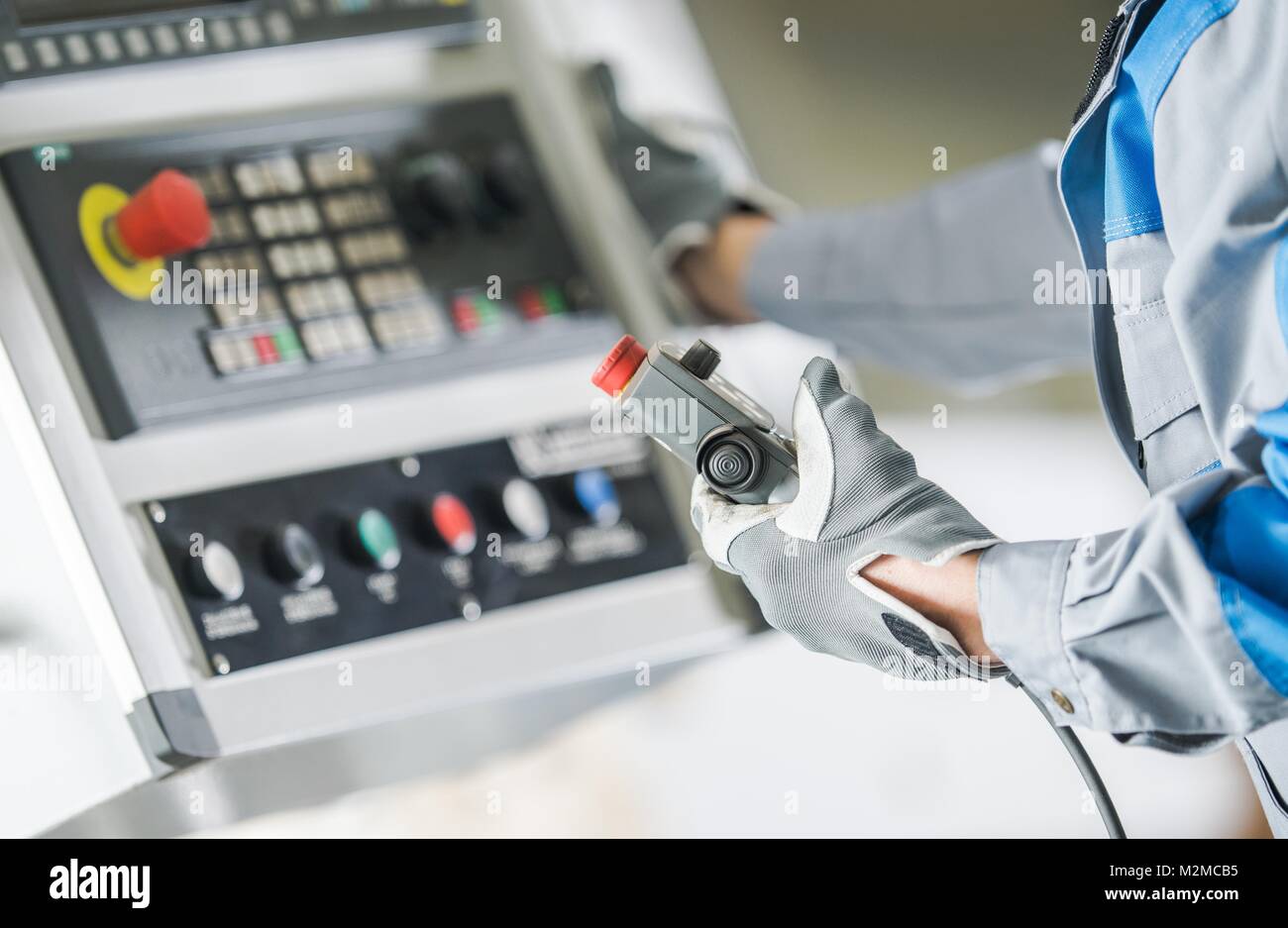 CNC-Drehmaschine Control Panel. Arbeitnehmer mit Wired Remote Operating CNC-Funktionen. Stockfoto