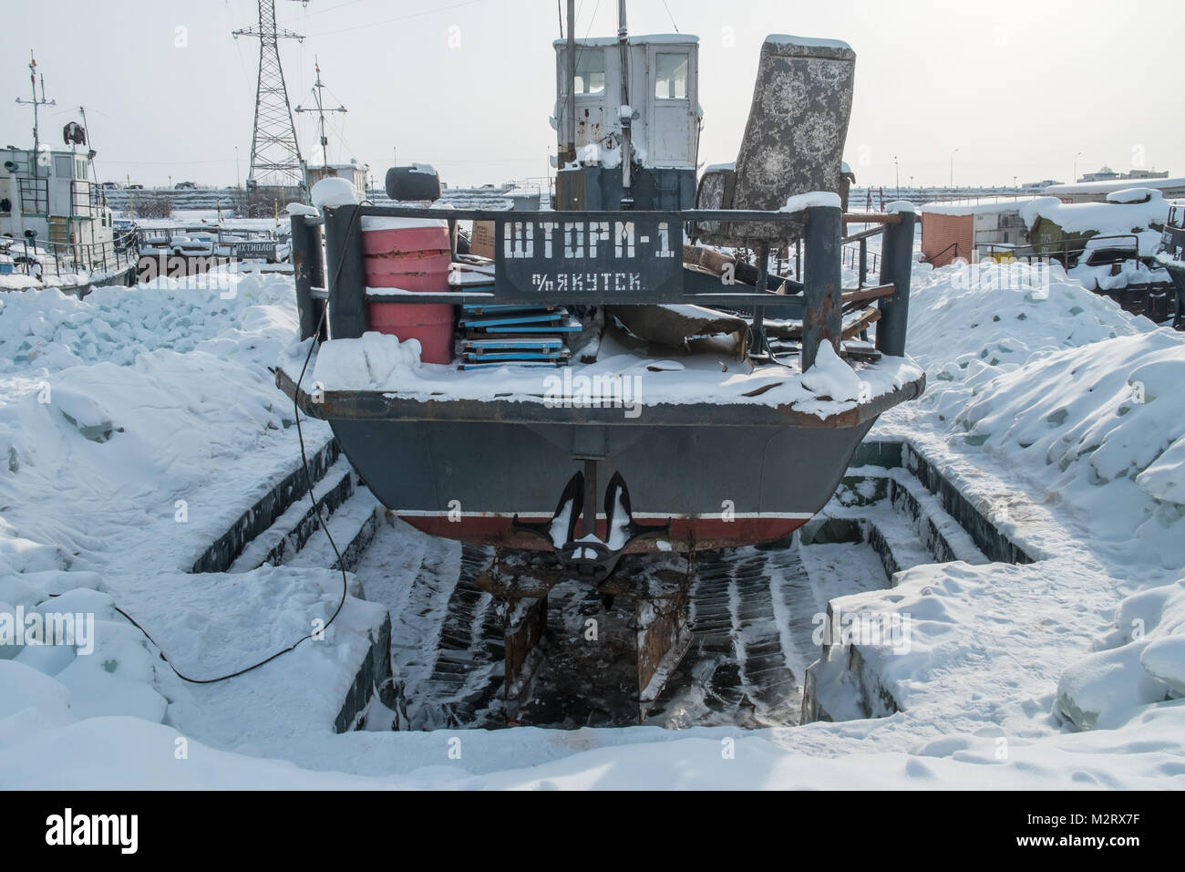 Ein Schiff in einen Hafen auf dem Fluss Lena in Jakutsk gefroren, in Sibirien ist ein wichtiger Hafen an der Lena. Es wird von der Jakutsk Flughafen sowie die s Stockfoto