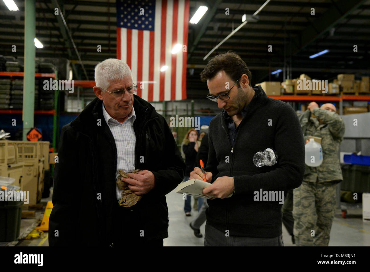 Simon Sinek Zeichen ein Buch für James Pacer, 436Th Airlift Wing Transition Assistance Program Manager, nach einem Briefing mit Team Dover Kundenservice Flieger Feb 1, 2018, in Dover Air Force Base, Del Sinek die Bedeutung der guten Führung erklärt und wie man sie bezieht sich auf die Kundenerfahrung. (U.S. Air Force Stockfoto