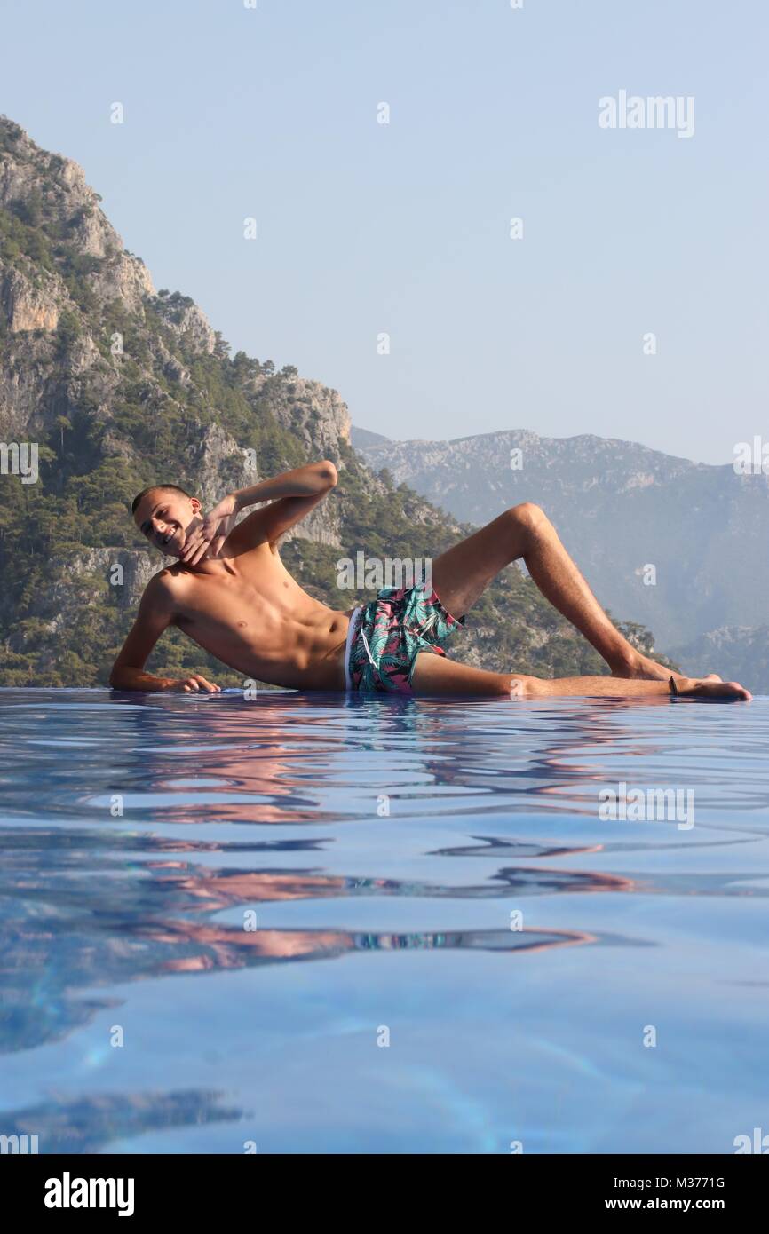 Ein unbekannter Jugendlicher am Rande der einen Infinity-pool während auf Ferien in der Türkei Stockfoto