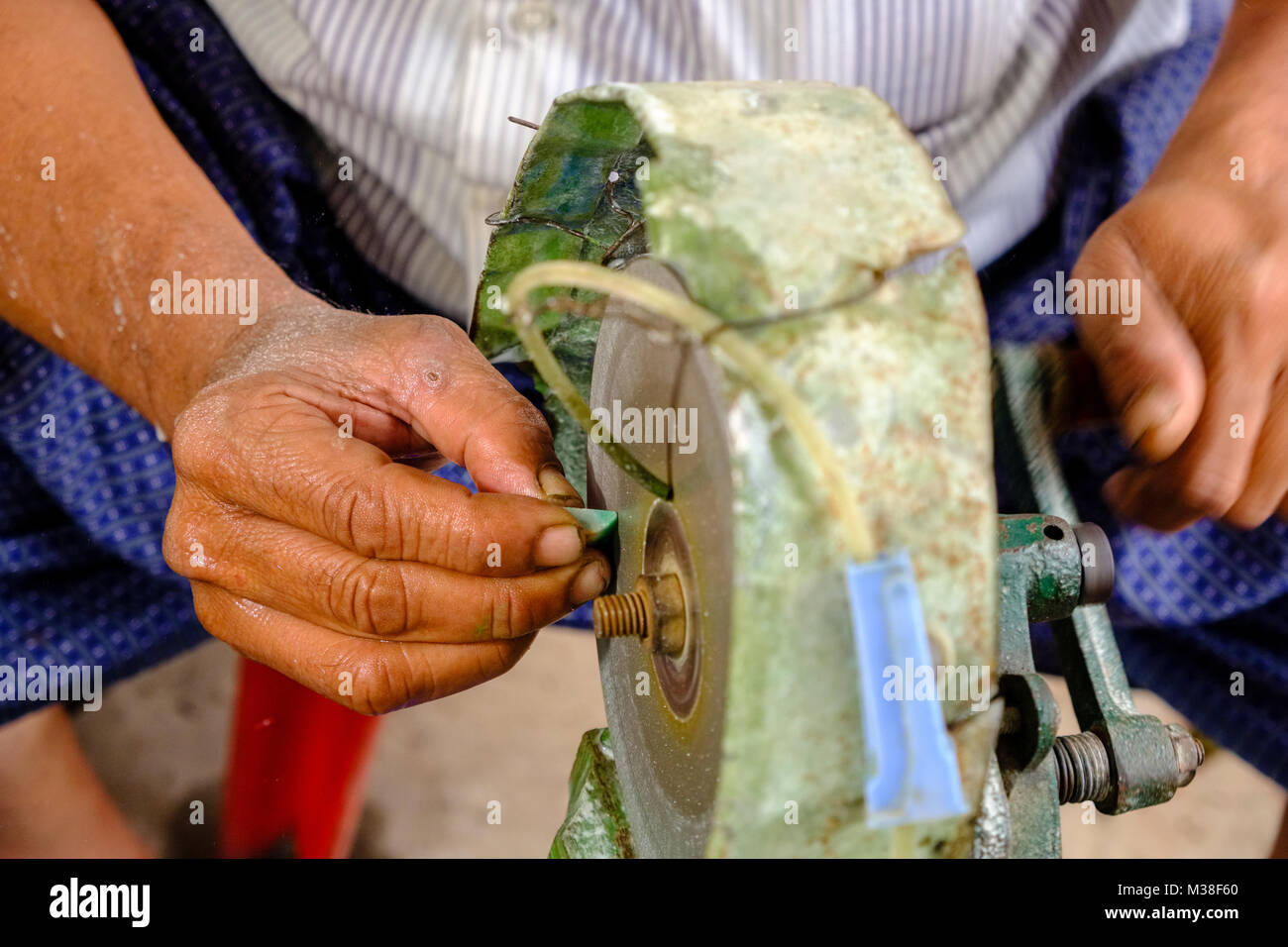 Nahaufnahme eines Arbeitnehmers schleifen Edelsteine jade Steine in der Jade Markt Stockfoto