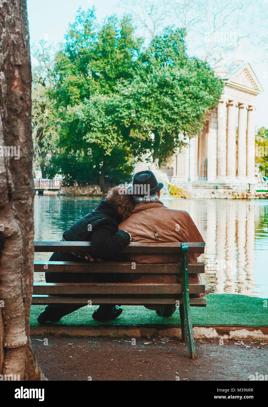 Paar Senioren sitzen an einem Fluss Stockfoto