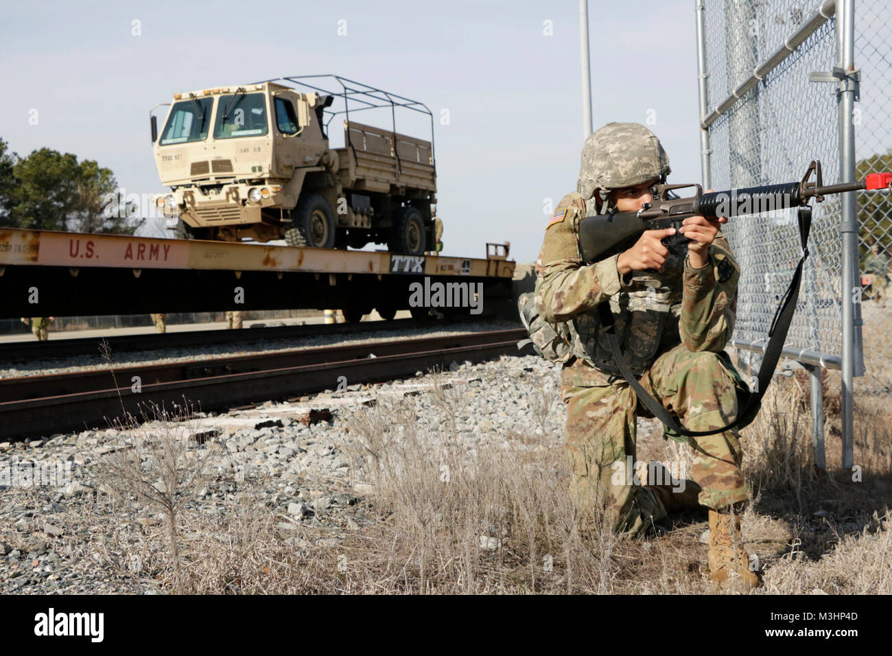 Us-Armee Soldat von 1 Platoon zu 149 Seaport Operationen Firma zugewiesen, 10 Transport Bataillon, 7 Transport Brigade (Auslandseinsätze) zieht Sicherheit, während Soldaten führt des Schienenkopfes Roll on Roll off Operationen während Führungskräfte Training Zeit an Ft. Eustis, Virginia. Am 1. Februar 2018. Stockfoto