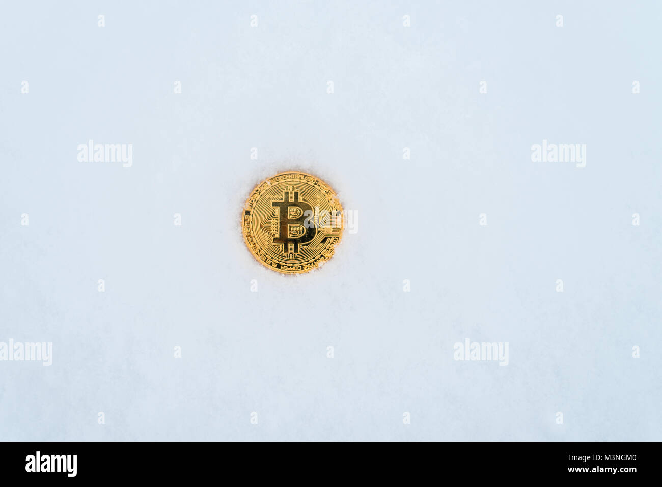 Die verlorene Münze von crypto-Währung im Winter im Schnee. Gold bitcoin im Schnee allein. Stockfoto