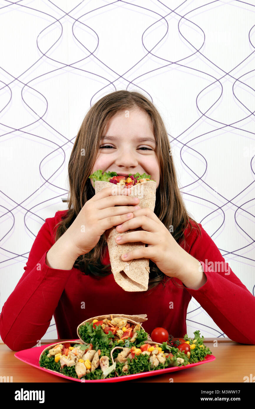 Hungrige kleine Mädchen essen burritos Fast Food Stockfoto
