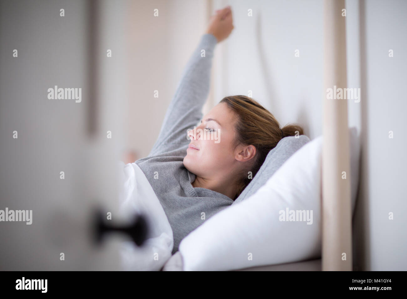 Junge erwachsene Frau Aufwachen am Morgen Stockfoto