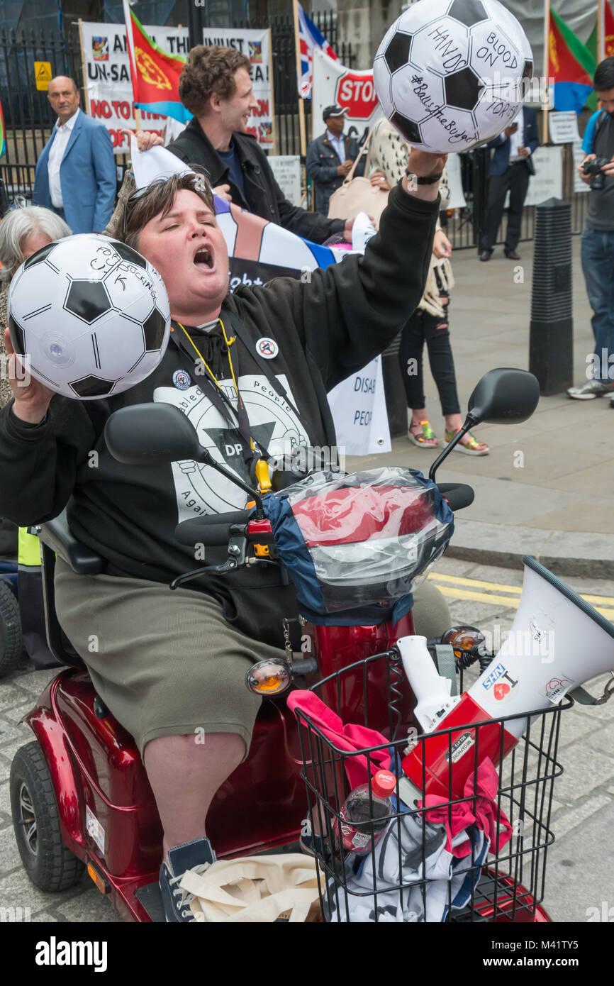 Paula Peters der DPAC-hält zwei Fußbälle mit Nachrichten für die GOVERNENT an behinderte Menschen gegen Kugeln Schnitte', um den Haushalt" als Sie über Whitehall geht sie in Downing St. zu werfen Stockfoto