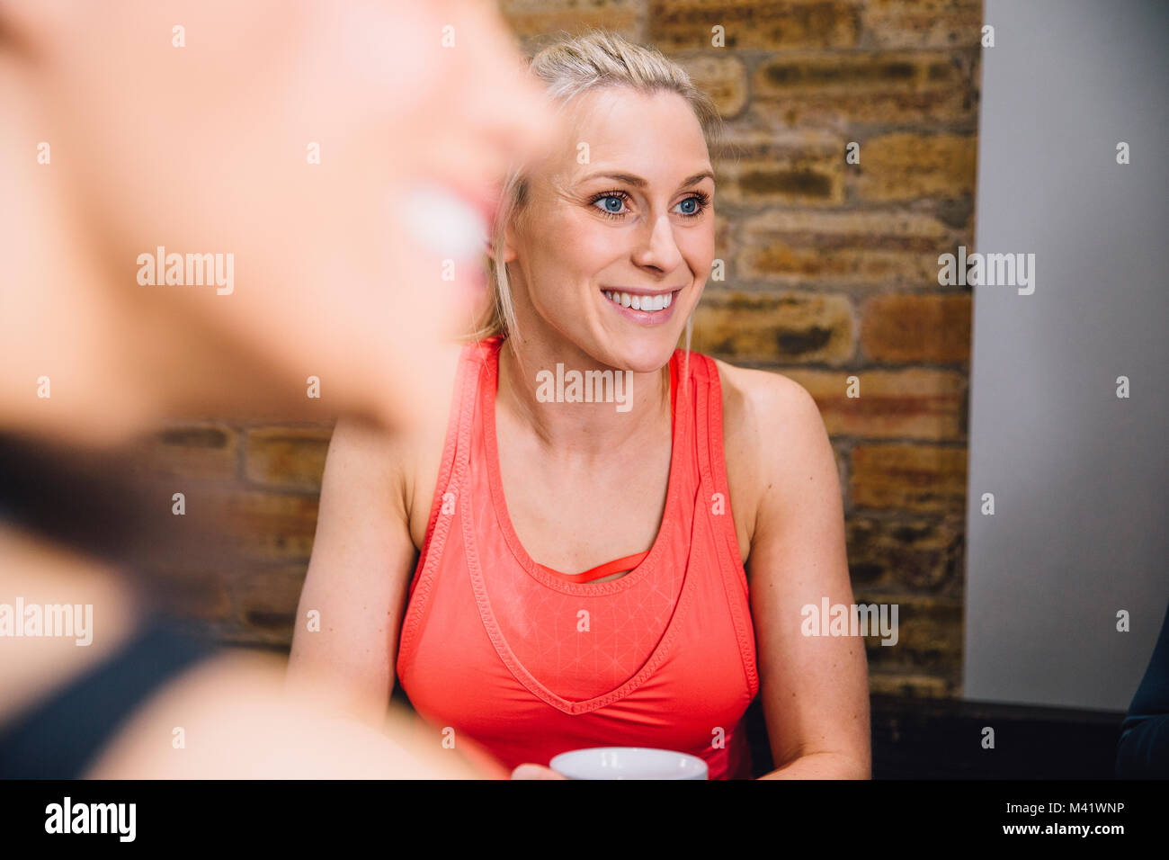 Nahaufnahme einer Frau in einem Café genießen eine Tasse Tee. Sie ist Geselligkeit mit Freunden. Stockfoto