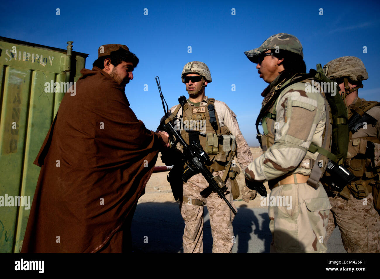 Us-Marines mit Task Force (Südwest) (TFSW) Treffen mit afghanischen Polizisten während einer Patrouille in der Nähe von Bost Flugplatz, Afghanistan, Jan. 27, 2018. Die Begegnung half TFSW's Verpflichtung zur Unterstützung der afghanischen nationalen Verteidigungs- und Sicherheitskräfte (ANDSF) mit mehr Funktionen für zu helfen, eine hohe betriebliche Tempo mit konstanten Betrieb um Provinz Helmand pflegen bekräftigen. (U.S. Marine Corps Foto von Sgt. Sean J. Berry) Stockfoto