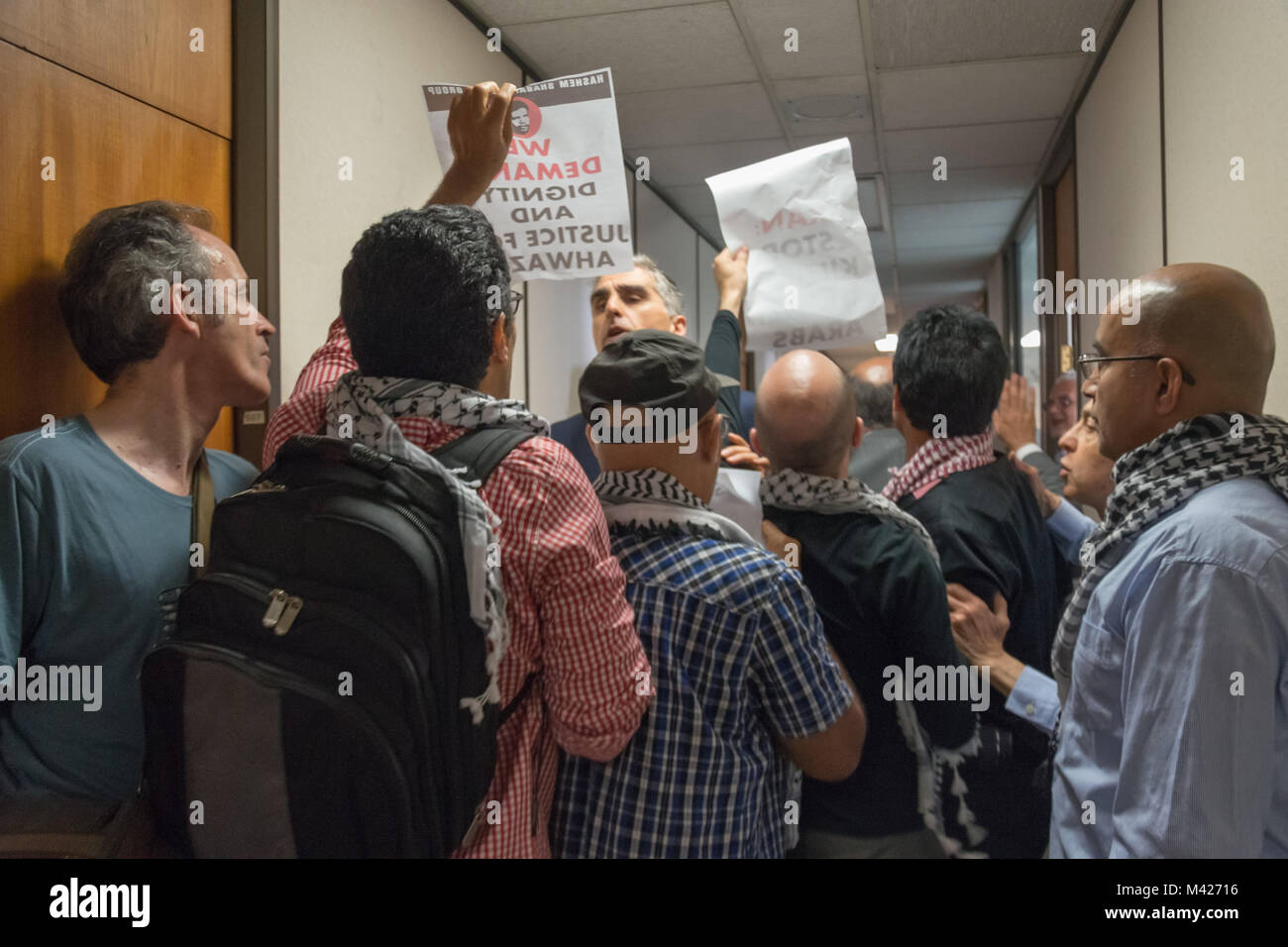 Die Demonstranten und Menschen aus dem geheimen UK-Iran business meeting in NIOC argumentieren im Korridor vor der Sitzung und die Demonstranten halten Plakate fordern Würde und Gerechtigkeit für die Ahwazis. Stockfoto