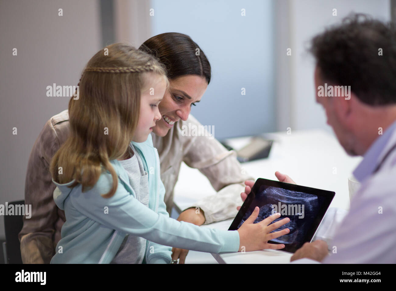 Hausarzt mit Mutter und Tochter ein Baby Ultraschall Stockfoto