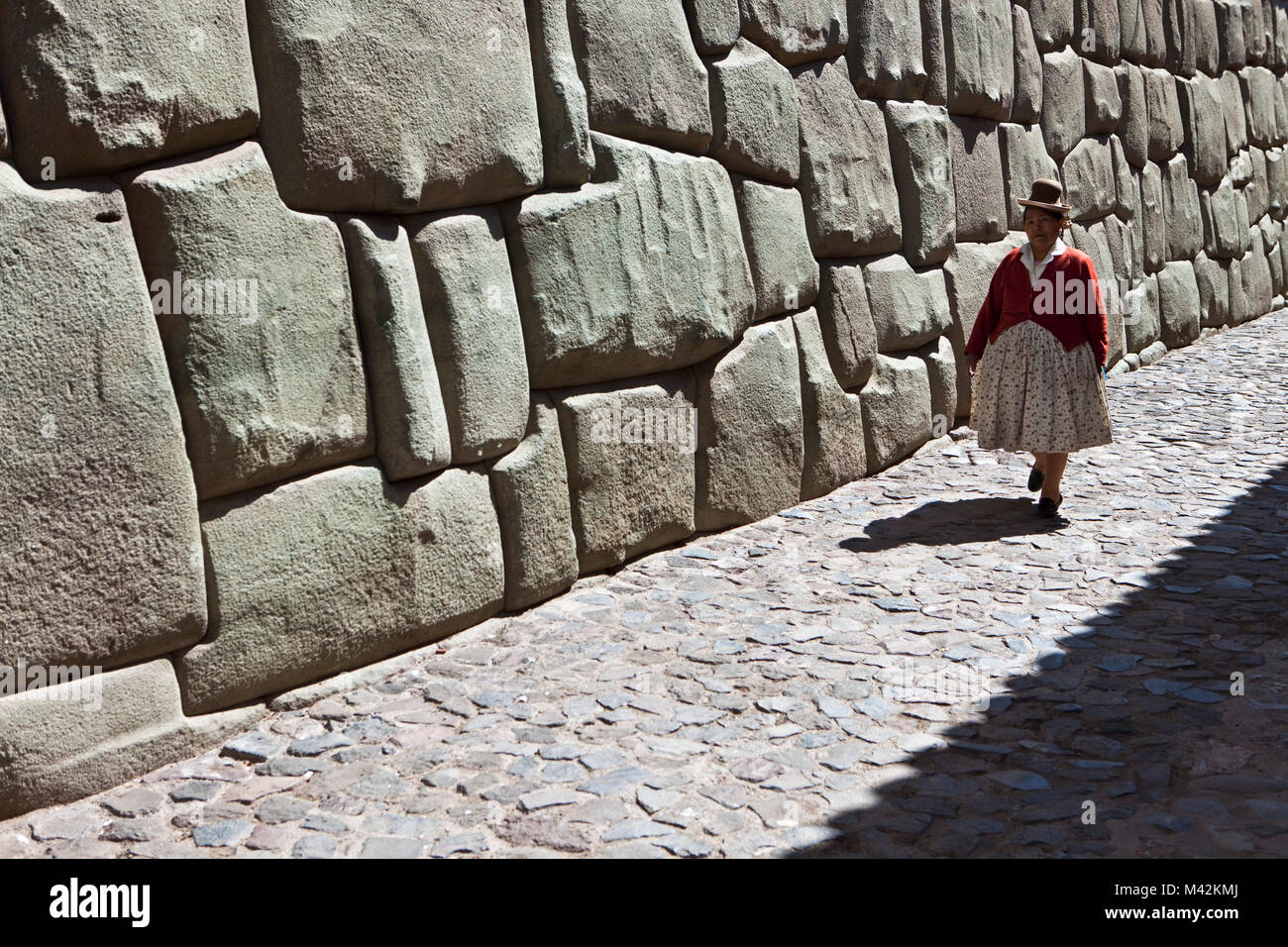 Peru, Cusco, Cuzco, Wand des Museum für religiöse Kunst. Beispiele für polygonale Mauerwerk. Indische Frau. Unesco-Weltkulturerbe. Stockfoto
