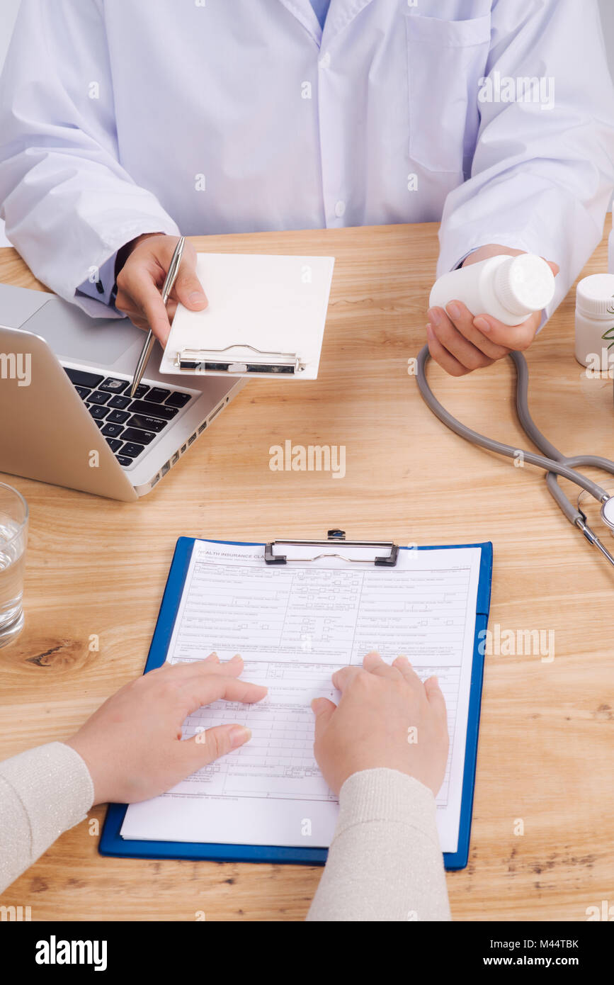 Stethoskop, ärztliche Verschreibung Form liegen vor dem Hintergrund eines Arztes und Patienten diskutieren Gesundheit Prüfungsergebnisse. Stockfoto