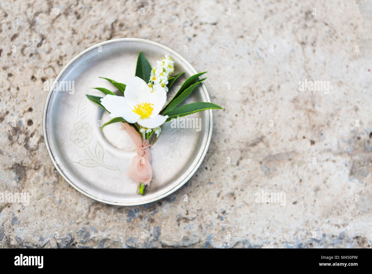 Knopfloch für den Bräutigam auf dem grauen Beton Hintergrund. Nahaufnahme Stockfoto