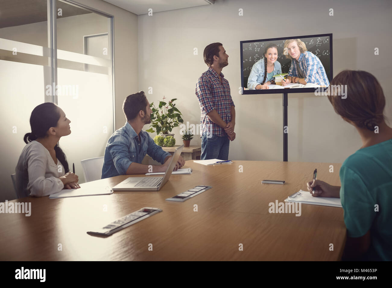 Zusammengesetztes Bild von College-Studenten, die Hausaufgaben in Bibliothek Stockfoto
