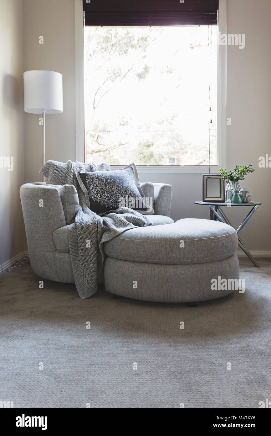 Luxus grau Schlafzimmer Ecke Sessel unter einem Fenster Stockfoto