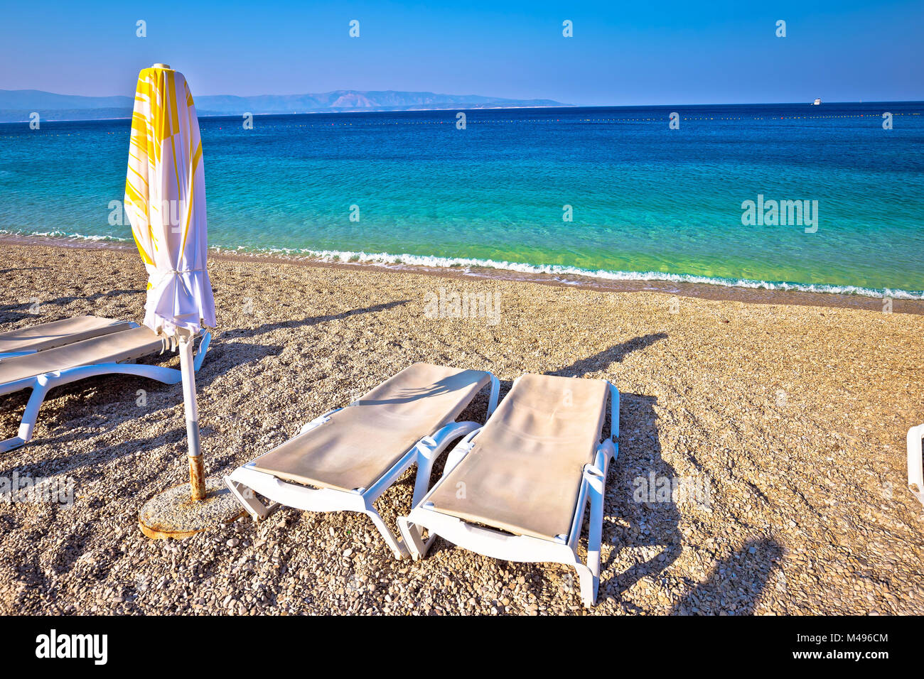 Idyllische türkis Strand Sonnenschirm und Liegestuhl Stockfoto