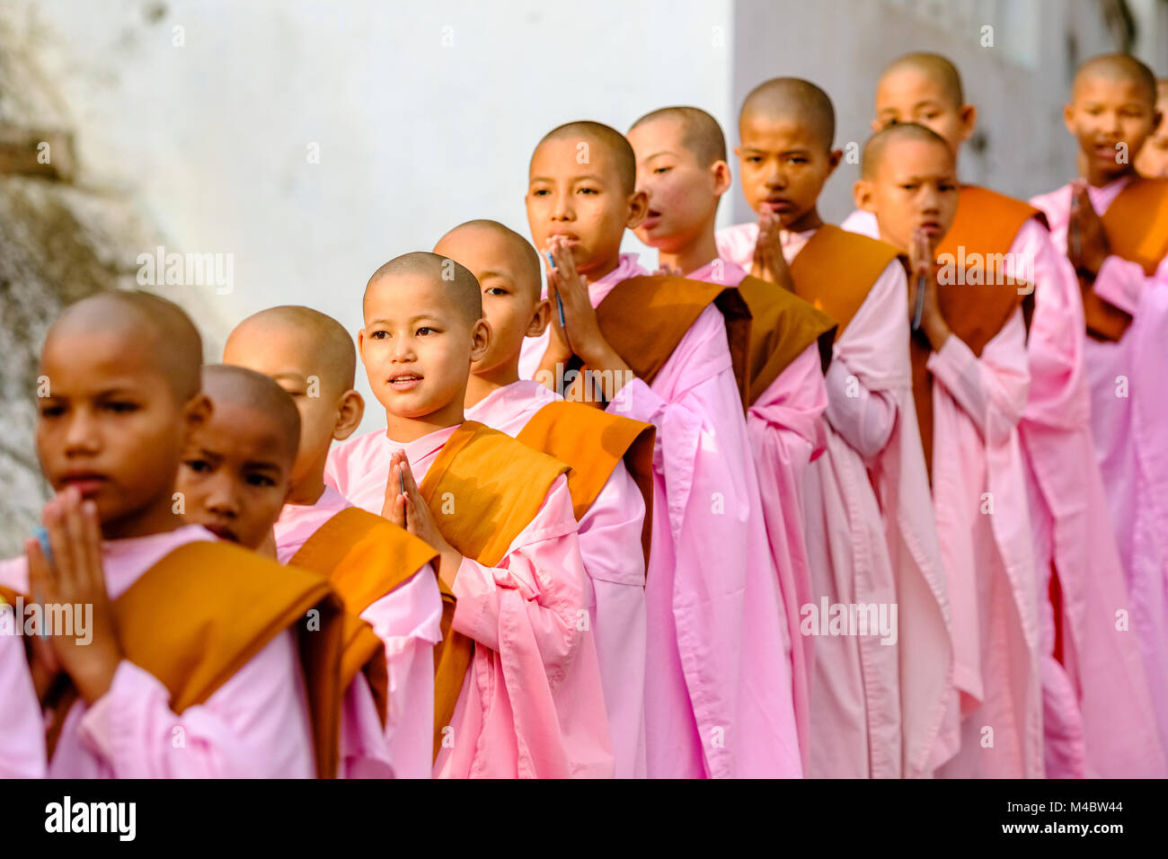 Buddhistische Nonnen in Warteschlange stehen in einer langen Reihe Spenden in ein Kloster zu erhalten Stockfoto