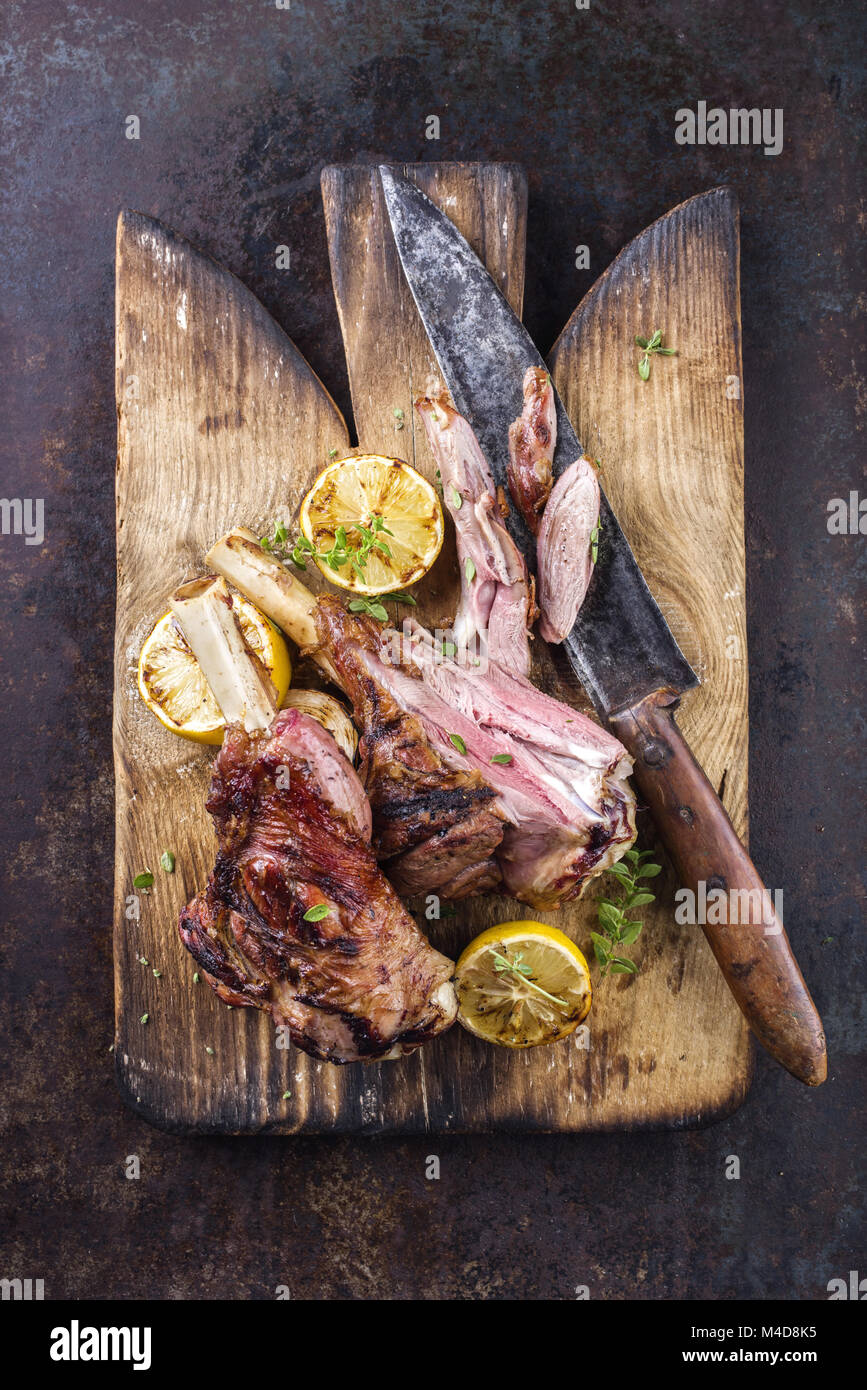 Grill Lamm Knuckles auf altem Schneidebrett Stockfoto