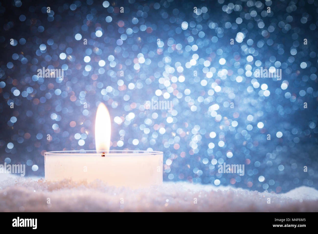 Chistmas Kerze glühende auf Glitzer Hintergrund. Stockfoto